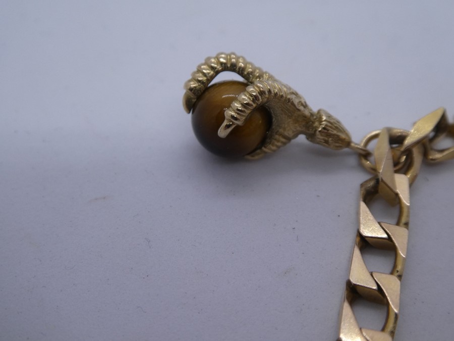 9ct yellow gold identity bracelet, hung with a single charm of a claw and tigers eye ball, 14.7g app - Image 4 of 4