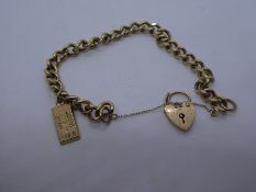 9ct yellow gold curb link bracelet with heart shaped padlock clasp, and safety chain, hung with a go