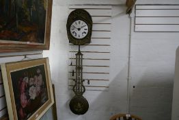 An old French farmhouse clock having embossed brass decoration