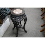 A Chinese carved hardwood jardiniere stand having a marble top 62cm