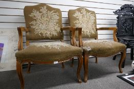 A pair of French beech open armchairs having floral upholstery - joints wobbly