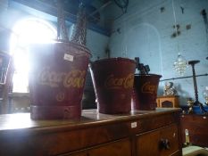 Three Coca-Cola buckets