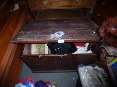 An old pine blanket box containing clothes and similar