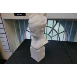 A marble bust of young girl on square base