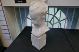 A marble bust of young girl on square base