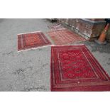 An old Bokhara having elephant pad design, modern Bokhara and one other rug, the largest is 192 x 14