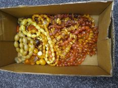 Tray of various amber coloured necklaces, earrings etc