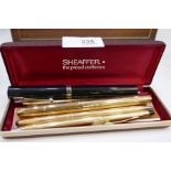 A Sheaffer gilt fountain pen and other pens