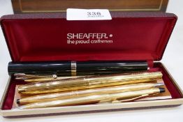 A Sheaffer gilt fountain pen and other pens