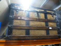 Two wood and metal bound large storage trunks