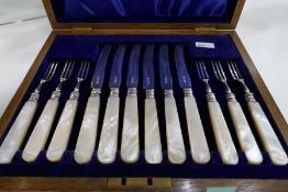 A very nice early 20th Century high quality set of heavy silver, with Mother of Pearl handles, knive