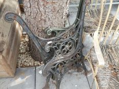 Two pairs of cast iron bench ends, one depicting a lion mask