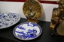 An oriental circular shaped vase decorated Peacock and flowers and a Japanese charger decorated bird