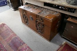 A Chinese carved camphor wood chest, decorated figures - 111cm