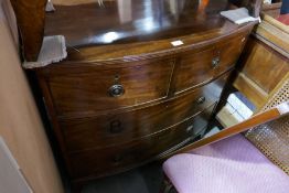 An antique mahogany bow front chest having two short and two long drawers