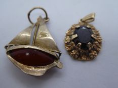 9ct yellow gold garnet set pendant marked 375, together with a 9ct Nuvo boat charm, with a hardstone