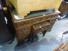 A reproduction mahogany twin pedestal desk having nine drawers