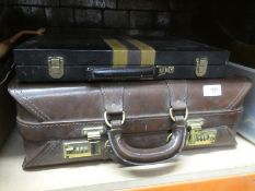 A leather briefcase, a box of mixed china and walking sticks and stand