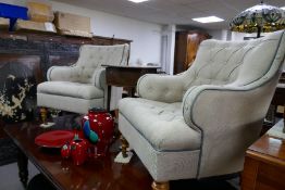 A pair of modern armchairs having buttoned upholstery, on turned front legs
