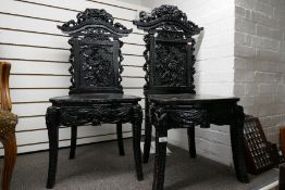 A pair of Chinese carved hall chairs decorated flowers