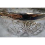 A very large heavy cut glass bowl with a silver rim hallmarked Birmingham 1942, Hukin and Heath as w