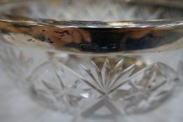 A very large heavy cut glass bowl with a silver rim hallmarked Birmingham 1942, Hukin and Heath as w