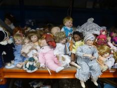 A shelf of collector's dolls including Ashton Drake