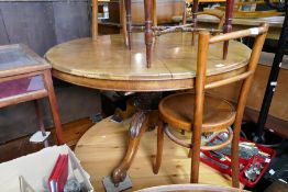 A Victorian walnut circular dining table with carved pillar