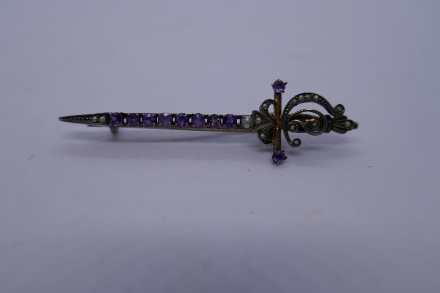 Victorian brooch in the form of a sword inset with 11 amethyst and seed pearls, marked 900, 6cm