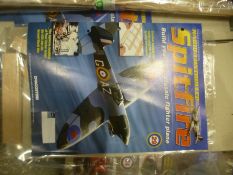 Two boxes of De Agostini radio controlled Spitfire magazines with parts to build Spitfire, including