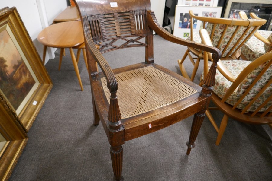 A Regency mahogany open armchair having cane seat on fluted front legs