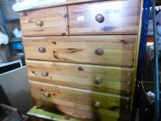 Two modern pine chests of drawers and a similar bedside chest