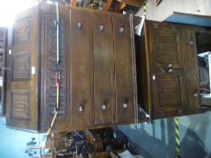 A reproduction oak bureau and 2 door one drawer storage cupboard