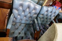 A pair of Gainsborough style leather armchairs with buttoned seat and back