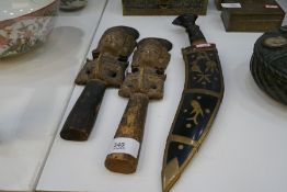 Two similar Bali wood carvings and a Kukri in brass decorated scabbard