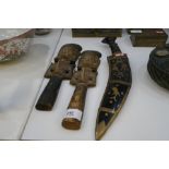 Two similar Bali wood carvings and a Kukri in brass decorated scabbard
