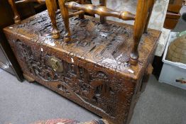 An old Chinese carved camphor wood chest decorated figures in landscape, 104cm