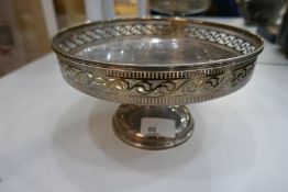 A large silver fruit bowl on a pedestal foot, with pierced rim decoration. Hallmarked Sheffield 1927