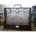 A reproduction mahogany and plated 3 decanter tantalus