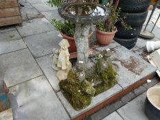 Stone effect bird bath depicting a boy, and 4 garden ornaments of men and children