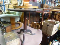 An antique oak tripod table