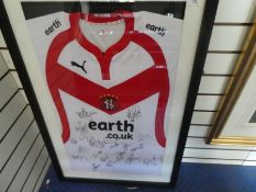 A St Helens rugby shirt bearing signatures, presumably of the team, framed and glazed
