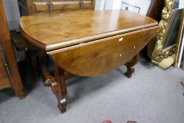 A reproduction Spanish style 2 flap table and a similar oblong coffee table