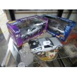 Two boxed die cast models of The Back to The Future Delorean and another by Welly unboxed