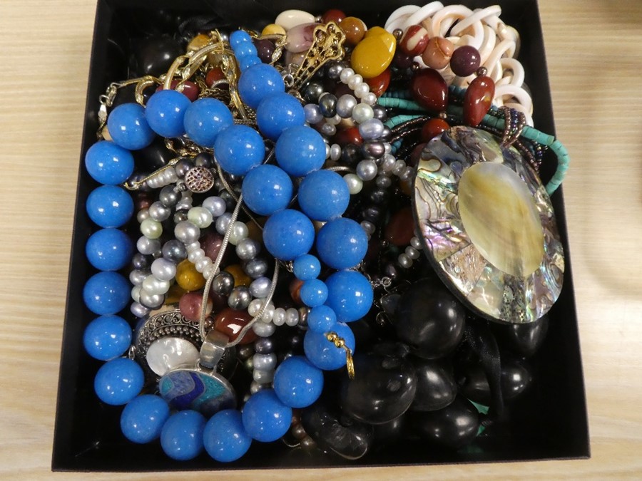 A box of mixed costume jewellery to include a silver and mother of pearl pendant on chain, hardstone