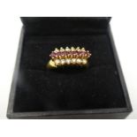 Pretty 18ct yellow gold dress ring, with 7 central rubies flanked by 12 diamonds marked 750, size Q,