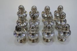 A quantity of twelve silver half reeded design peppers marked 800, total gross weight 8.26ozt approx