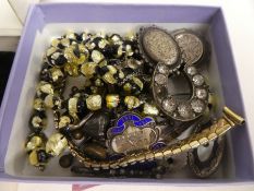 A box containing silver brooches, lockets, badges, etc and a box containing yellow metal brooches, e