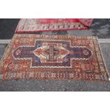 An old geometric rug having central design, 214 x 120cm