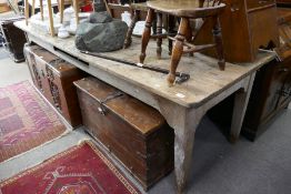 An old pine oblong kitchen table on square legs, 275cm